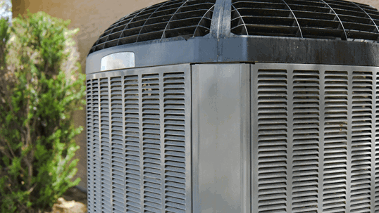 A large, gray outdoor air conditioning unit