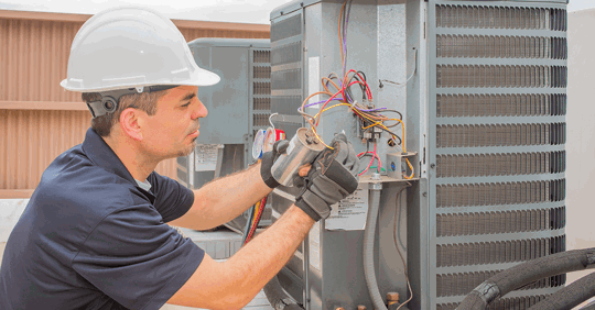 Service tech fixing an HVAC unit