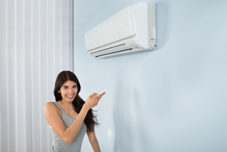 A woman is pointing at AC unit